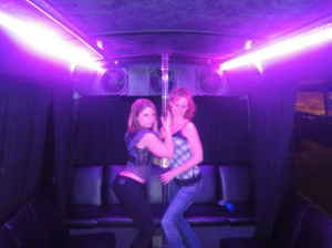 1991 Ford Bronco - Two women are inside a vehicle illuminated by purple lights, with a pole visible.