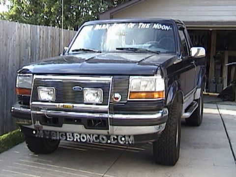 1995 Ford Bronco - This 1995 Ford Bronco is shown from the front, a chrome bumper and grille, and text on the windshield.
