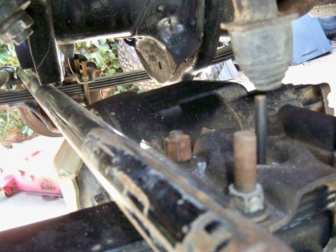 1985 Ford Bronco - Close-up view of a vehicle's undercarriage, focusing on suspension parts.
