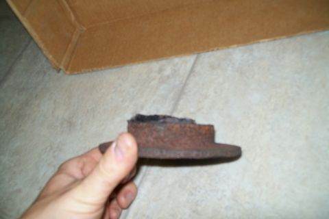 2000 Chevrolet Tahoe - A heavily rusted brake rotor is shown, likely a part from a vehicle.