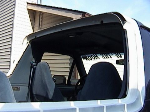 1995 Ford Bronco - Interior view of a 1995 Ford Bronco, showing the seats and a reflection in the rear window.