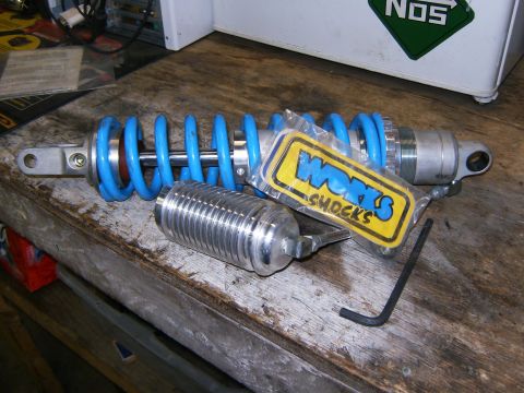 2000 Ford E350 - A Works Shocks brand coilover shock absorber and its components are laid out on a workbench.