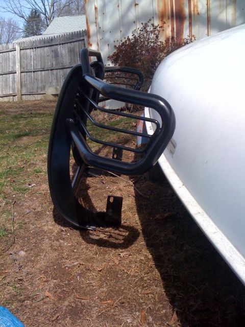 1995 Ford Bronco - A black bull bar is mounted to the front of a white vehicle, parked outdoors.
