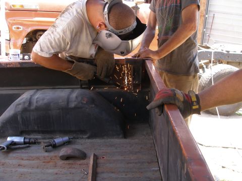 1969 Ford F-250 - Welding repairs are being performed on the frame of a 1969 Ford F-250 truck bed.