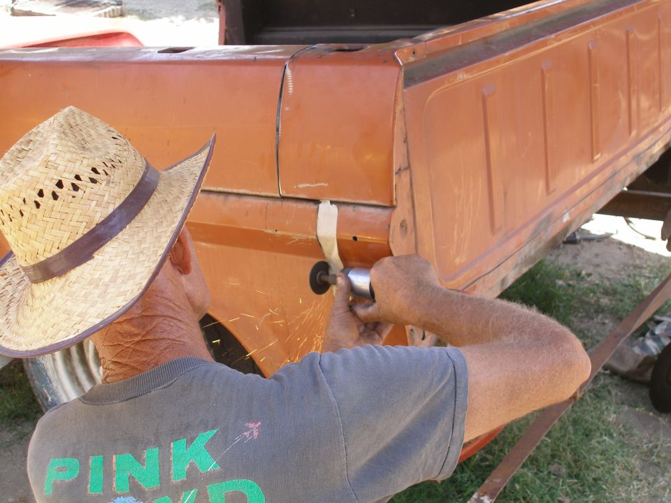 Man grinding on orange truck bed