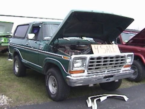 1995 Ford Bronco - This green Ford Bronco is for sale, with its hood open to reveal the engine compartment.