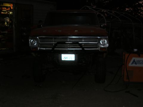 1969 Ford F-250 - This 1969 Ford F-250 pickup truck is shown from the front, a custom bumper and modified headlights.