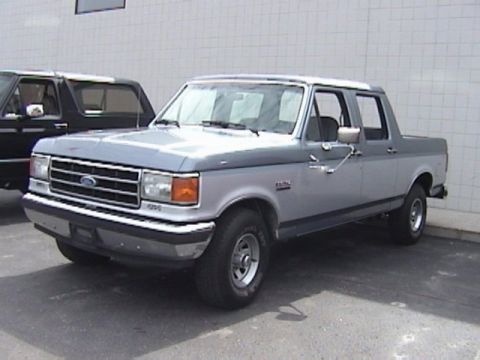 1995 Ford Bronco - This two-tone pickup truck is shown from the front 3/4 angle. The body style suggests a 1995 model year.