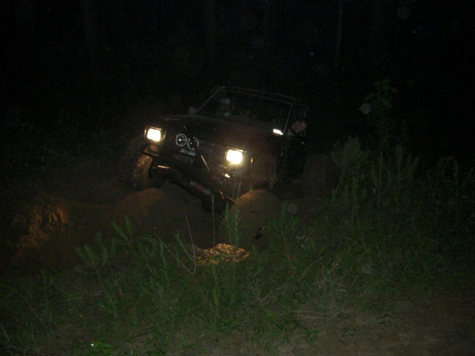 1984 Ford Bronco II driving off-road at night