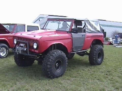 1995 Ford Bronco - This lifted Ford Bronco features aftermarket doors and a front-mounted winch, suggesting a custom build.