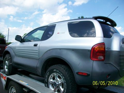 1999 Isuzu Vehicross - This silver SUV features unique body paneling and dark grey fender flares, seen from a three-quarter front perspective.
