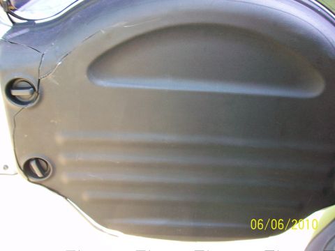 1999 Isuzu Vehicross - A cracked black plastic panel with visible latches and ridges is shown in a close-up view.