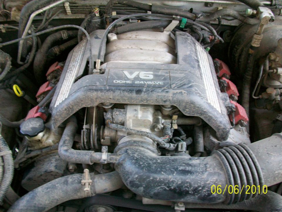 Dusty V6 DOHC 24-valve engine bay with red coil covers