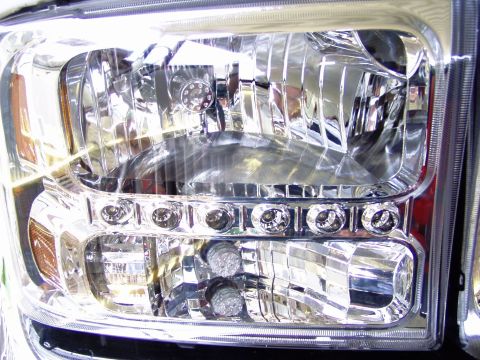 2001 Ford Excursion - Headlight assembly from a Ford Super Duty truck, likely from the mid-2000s model years.