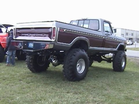 1995 Ford Bronco - Rear view of a lifted 1979 Ford pickup truck parked on grass.