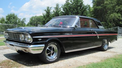 1992 Ford Mustang - This classic black Ford Fairlane 500 features a distinctive red stripe along its side.