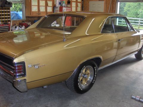 1970 Chevrolet Camaro - This gold 1967 Chevrolet Chevelle SS is parked in a garage with the door open.