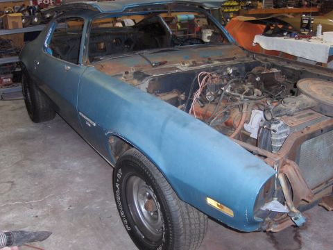 1970 Chevrolet Camaro - This 1970 Chevrolet Camaro is in a state of disrepair, with its hood removed and visible rust on the body.
