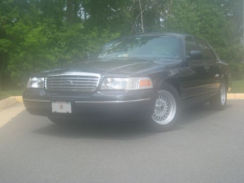 1999 Ford Crown Victoria - Front 3/4 view of a 1999 Ford Crown Victoria with aftermarket wheels.