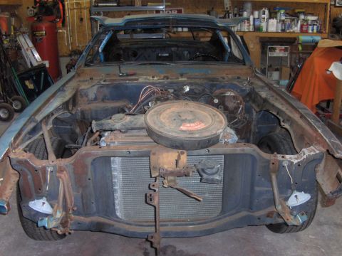 1970 Chevrolet Camaro - This vehicle is in a state of disassembly, with its front end stripped bare, revealing the engine compartment and radiator.