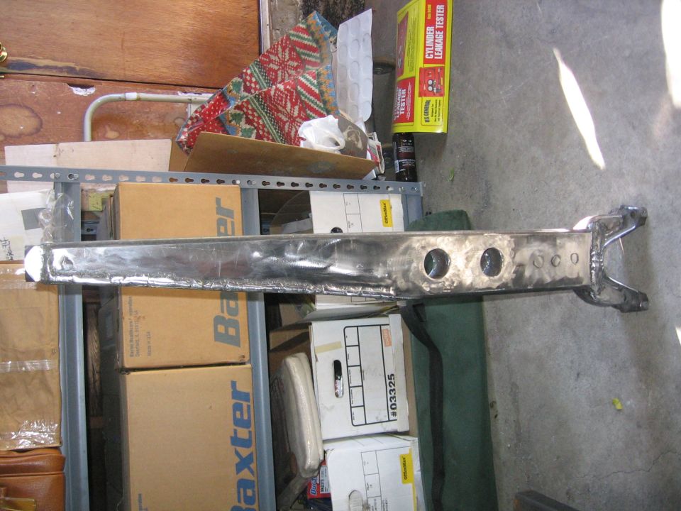 Modified vehicle axle housing with two large holes and several smaller ones