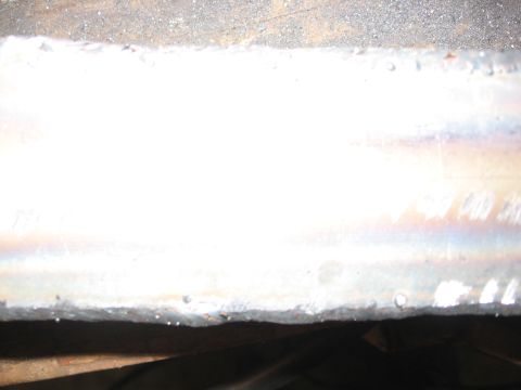 1989 Ford Bronco - A close-up view of a metal beam showing the results of a welding process.