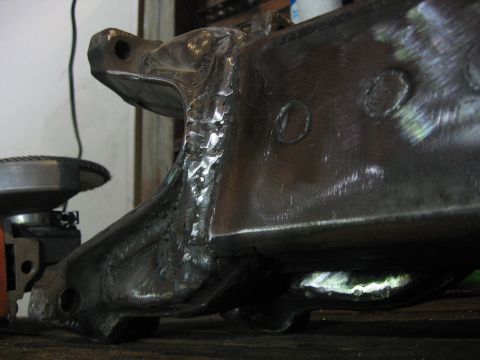 1989 Ford Bronco - A close-up view of a heavily modified metal component, likely undergoing repair or customization.