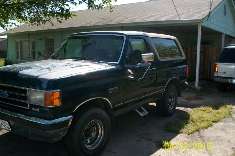 1991 Ford Bronco - This 1991 Ford Bronco is parked in front of a light blue house with a white trim.