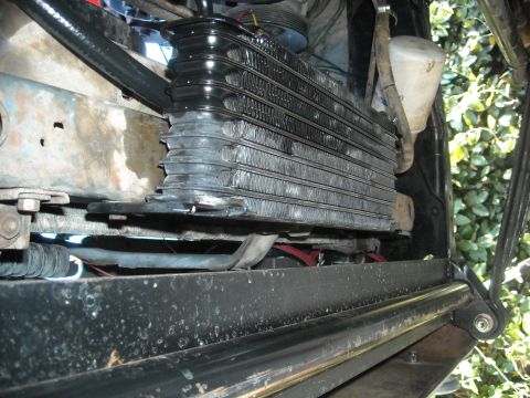 1985 Ford Bronco - Close-up view of a transmission cooler assembly, showing its fins and mounting hardware.