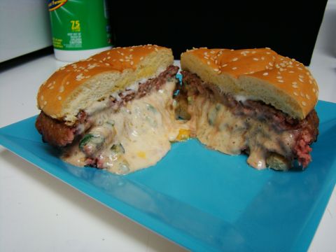 1989 Ford Bronco - A juicy cheeseburger, cut in half, reveals a generous amount of melted cheese oozing out over the patty and bun.
