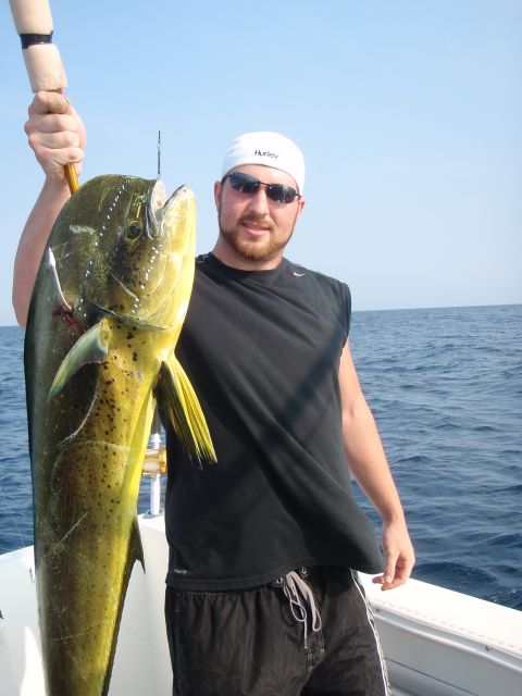 1995 Ford Bronco - Fisherman proudly displays a large mahi-mahi caught at sea.