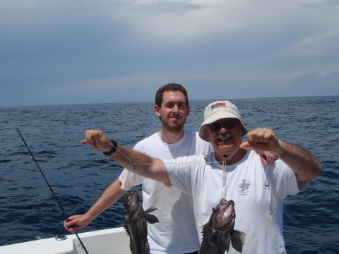 1995 Ford Bronco - Two men proudly display their catch while fishing at sea.