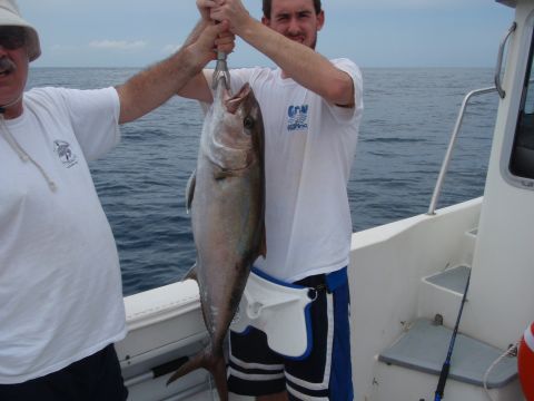 1995 Ford Bronco - Two men proudly display a large fish they caught while on a boat trip.