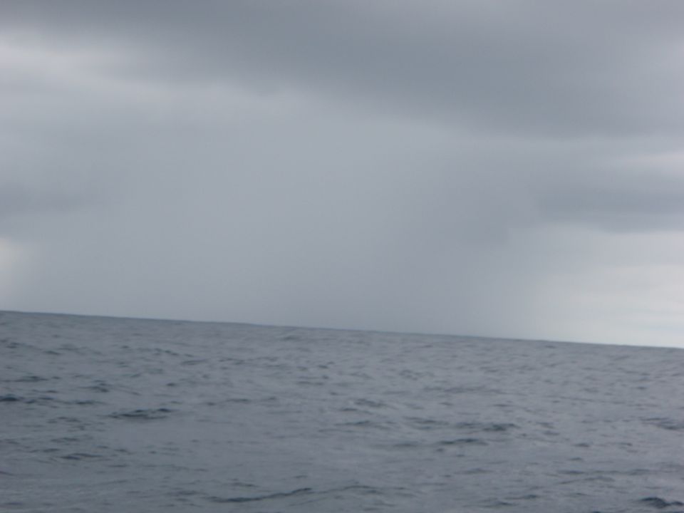 Ocean waves under a cloudy sky with a 'SUPERMOTORS' logo in the corner