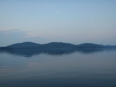 1995 Ford Bronco - Calm lake scene with rolling hills in the distance under a twilight sky.