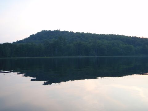 1995 Ford Bronco - A natural landscape a body of water and a dense forest on a hill.
