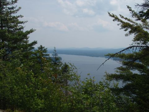 1995 Ford Bronco - View of a lake and hills from a wooded overlook, with a watermark at the bottom right.