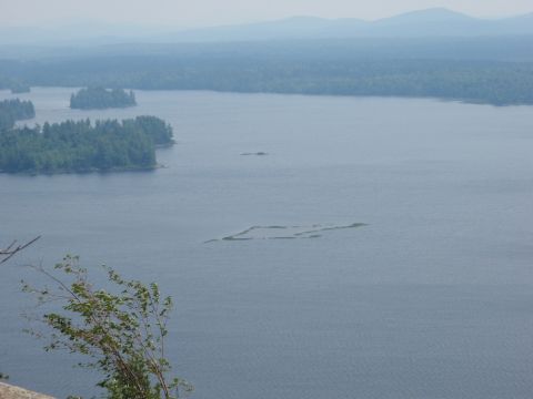 1995 Ford Bronco - A scenic view of a lake dotted with islands and surrounded by trees, with the Supermotors.net logo in the corner.