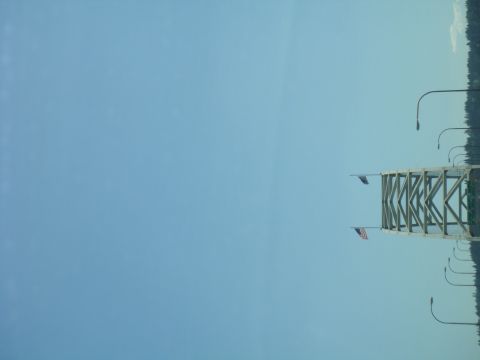 1992 Ford Bronco - Bridge scene with flags and streetlights, Supermotors.net logo present.