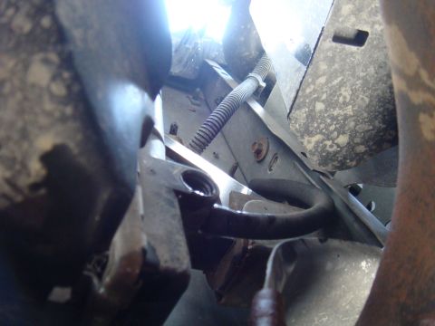 1992 Ford Bronco - Close-up of vehicle undercarriage, showing hoses and structural metal.