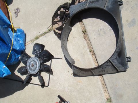1992 Ford Bronco - Radiator fan shroud and fan clutch assembly are laid out on a concrete surface.