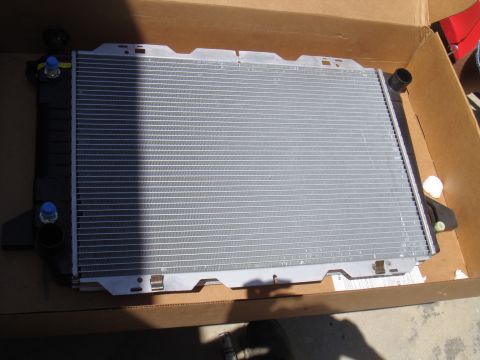 1992 Ford Bronco - A new radiator is shown inside its shipping box, ready for installation.