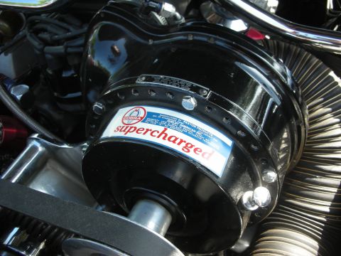 1992 Ford Crown Victoria - Close-up of a black supercharged engine component with a Cobra logo and readable text.
