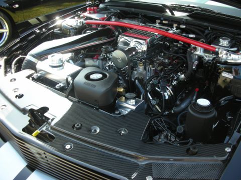 1992 Ford Crown Victoria - The engine bay of a modified vehicle displays a supercharger and custom components.