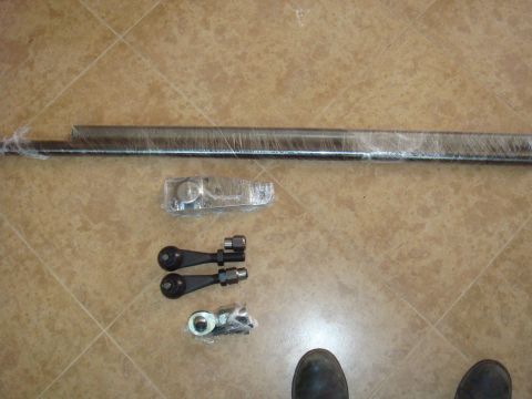 1992 Ford Bronco - New suspension parts laid out on a tiled floor, ready for installation.