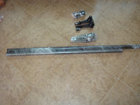 1992 Ford Bronco - Tie rod ends and drag link assembly, likely for an older truck or SUV, are laid out on a tiled floor.