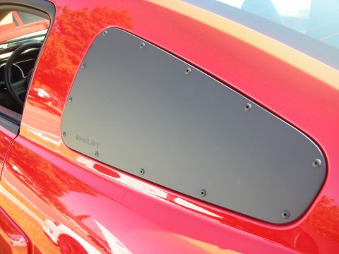 1992 Ford Crown Victoria - Close-up of Shelby quarter window louvers installed on a red vehicle.