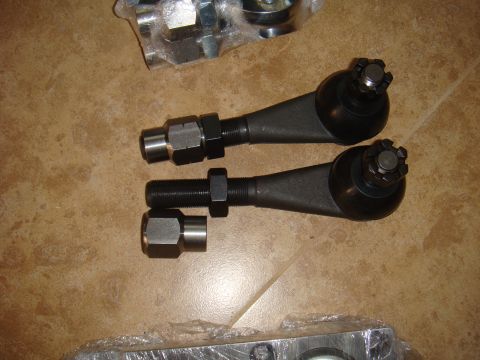 1992 Ford Bronco - Tie rod ends and associated hardware are laid out on a tiled surface.