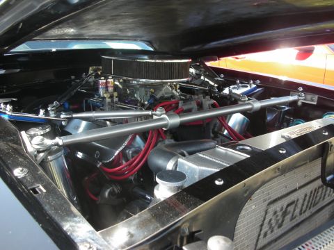 1992 Ford Crown Victoria - Close-up of a custom V8 engine with performance modifications and bright red spark plug wires.