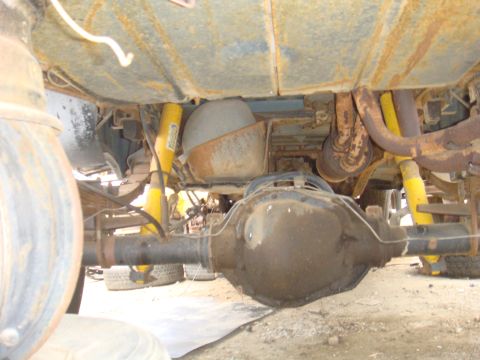 1992 Ford Bronco - Undercarriage view showing yellow shock absorbers and a substantial rear axle assembly.